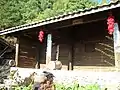 A house at the village. Seen hanging outside are bunches of dried chili.