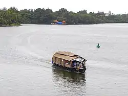 A House boat floating on Ashtamudi Lake- Scene from Thevally