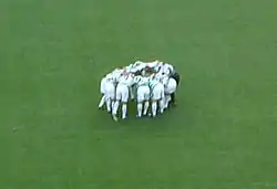 Picture of the Celtic players doing their customary pre-match "huddle"