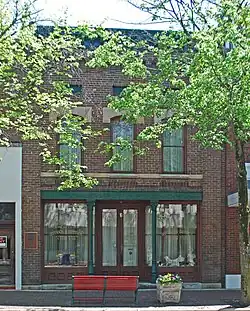 Brick three-story building sharing walls with buildings on both sides