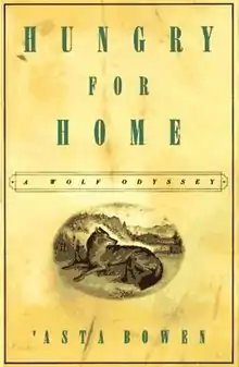 A yellow book cover, with the title, "Hungry for Home: A Wolf Odyssey", written in a prominent serif-font along the top and the author's name, 'Asta Bowen, at the bottom. Above the author's name, is an oval with a wolf lying in a grassy field with a forest visible behind it