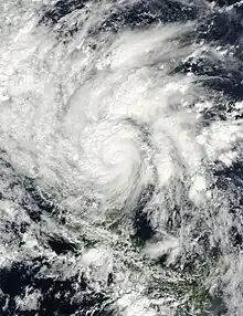 Satellite image of a tropical cyclone just onshore the Nicaragua coastline. Most of Central America is obscured by the storm except Panama which is located southeast of the cyclone. The storm displays the classic counterclockwise rotation of low-pressure systems in the northern hemisphere.