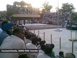 Flag lowering ceremony at Hussainiwala border, far side is Pakistan and near side is India