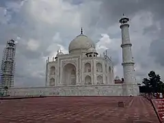 Taj Mahal in cloudy weather and its minaret under restoration