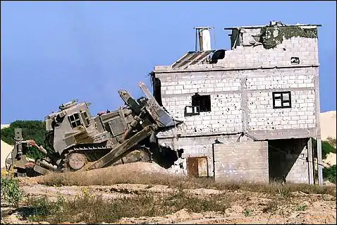 An IDF D9N (2nd generation armor) razing a house during the Second Intifada