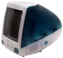 Three-quarters view of a bulbous, blue-and-white plastic computer. The front is dominated by a black computer screen, and tapers off in the back.