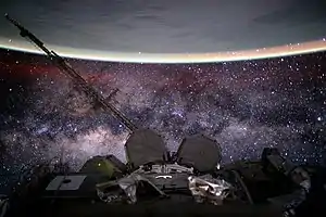 Image 42Outer space from the International Space Station at 400 km (250 mi) altitude in low Earth orbit. In the background the Milky Way's interstellar space is visible, as well as in the foreground, above Earth, the airglow of the ionosphere just below and beyond the so-defined edge of space the Kármán line in the thermosphere (from Outer space)