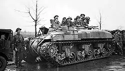 Troops sat in the top of a turretless tank