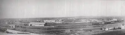 Panorama photo of groups of trains and buildings