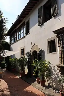 a typical Tuscan villa façade, white stucco with pieta serena surrounds to door and windows