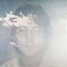 a hazy photo of John Lennon's face with the title and artist name printed on a white cloudlike area near his forehead.