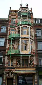 Asymmetric façade with curved lines of De Beck building by Gustave Strauven in Brussels (1905)