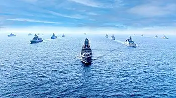 Smaller ships escorting two large ones