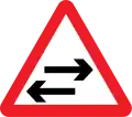 Two-way traffic on cross road ahead warning