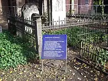 photograph of graves of Meta Klopstock, her husband and her husband's second wife, showing information board in German