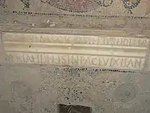 Marble inscription inserted in a mosaic