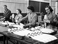 Image 68Workers inspecting practice bombs at a factory in South Australia during 1943 (from Military history of Australia during World War II)