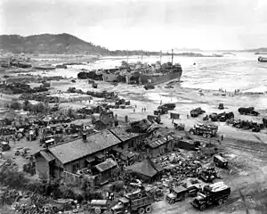 LST-611, one of four LSTs on beach, unloads at Inchon, 16 September 1950