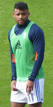 man in football training kit on a grass pitch