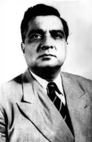 A black and white portrait of Iskander Mirza