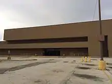 An abandoned department store building made of brown brick.