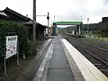 A view of the platforms and tracks. the sidings can be seen behind the footbridge to the left.