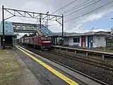 A freight train passing through a train station