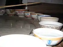 row of bowls, mostly filled with water