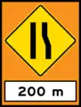 Road narrows on right (temporary sign)