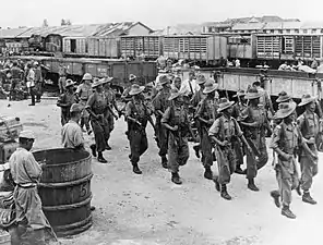 Image 29Gurkhas guide disarmed Japanese soldiers from Bangkok to prisoner of war camps outside the city, September 1945 (from History of Thailand)