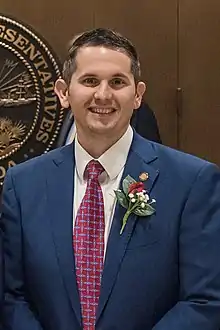 Head and shoulders of a smiling 30ish man with dark hair