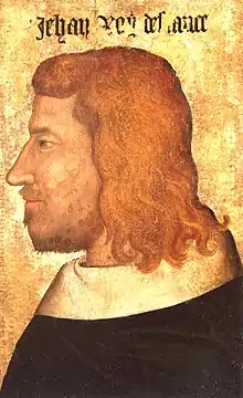 Profile of a bearded man with long red hair