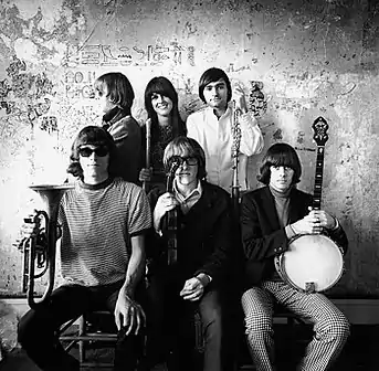 Jefferson Airplane photographed by Herb Greene at Herb Greene's dining room, San Francisco, in late 1966. Top row from left: Jack Casady, Grace Slick, Marty Balin; bottom row from left: Jorma Kaukonen, Paul Kantner, Spencer Dryden. A cropped version of this photo was used for the front cover of Surrealistic Pillow.