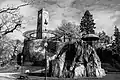 A view of Jenks Park, including the tower, a steel umbrella/pagoda, and natural rock formations.