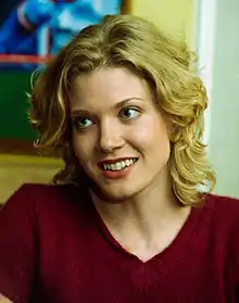 A headshot of a woman smiling toward the camera.