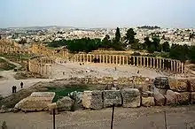 Image 15Forum of Gerasa (Jerash in present-day Jordan), with columns marking a covered walkway (stoa) for vendor stalls, and a semicircular space for public speaking (from Roman Empire)