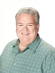 Photo of the upper body Jerry. Jerry is smiling in this image.