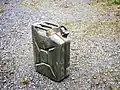 Jerrycan of fuel, WWII.  Middle handle for empty can;   two outer handles for two people carrying full can.