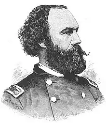  A black and white lithograph depicting a head and shoulders portrait of a United States Army officer of the Civil War era. He has curly black hair, a receding hairline and a large black mustache and beard. He is facing to the right and has a serious expression.