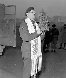 Captain Samuel Cass, a rabbi, conducting the first prayer service celebrated on German territory by Jewish personnel of the First Canadian Army near Cleve, Germany, 18 March 1945