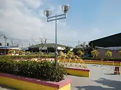 The Malabon City Library (center) and the Catmon Covered Court (right) behind the park