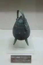 Bronze you tripod with zoomorphic image