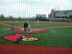 Patterson Stadium's batter's box, viewed from behind the protective netting