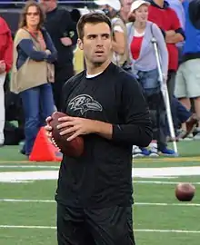 Joe Flacco with the Baltimore Ravens hands-off the ball during a game.