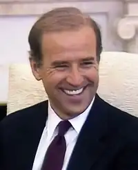 Photo of Biden smiling, looking to the side