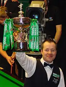 John Higgins holding a trophy