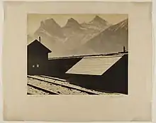 Black and white photograph of a house and mountains