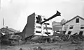 The John Schultz house in Johnstown after the flood. Skewered by a huge tree uprooted by the flood, the house floated down from its location on Union Street to the end of Main. Six people, including Schultz, were inside the house when the flood hit; all survived.