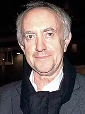 Jonathan Pryce looking to the camera