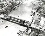 A monochrome photo of the Jones Bridge and its surrounding buildings destroyed